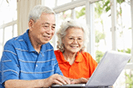 senior couple using laptop at home